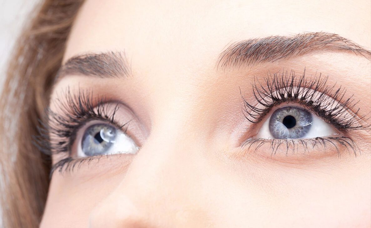 Close-up of woman's gray eyes with mascara